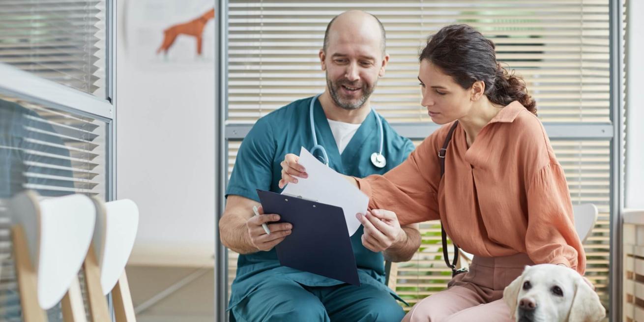 veterinarian discussing treatment costs with pet owner